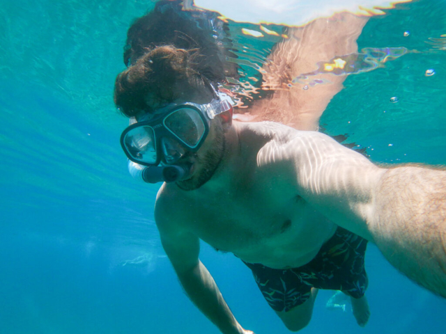 Diving in crystal clear water at Elafiti island and man with a snorkell