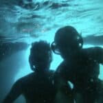 Couple Diving in the Blue Cave: Embracing Underwater Adventure