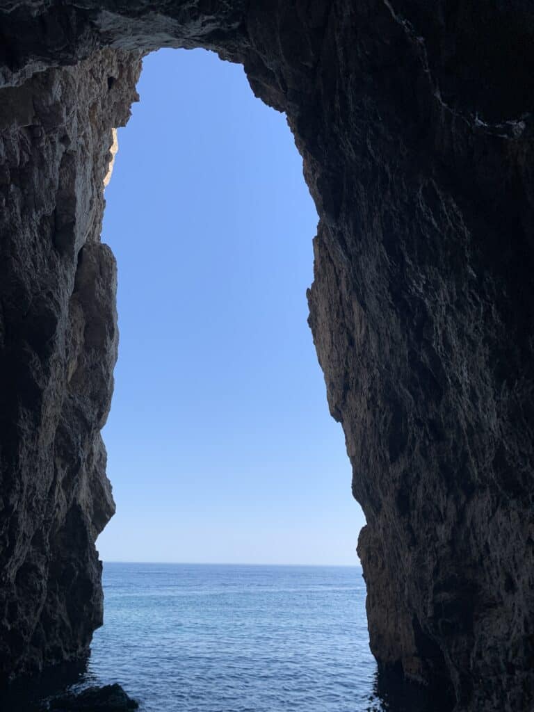 A secluded sea cave on Lopud Island, only reachable by boat, with crystal-clear waters and stunning rock formations near Dubrovnik.