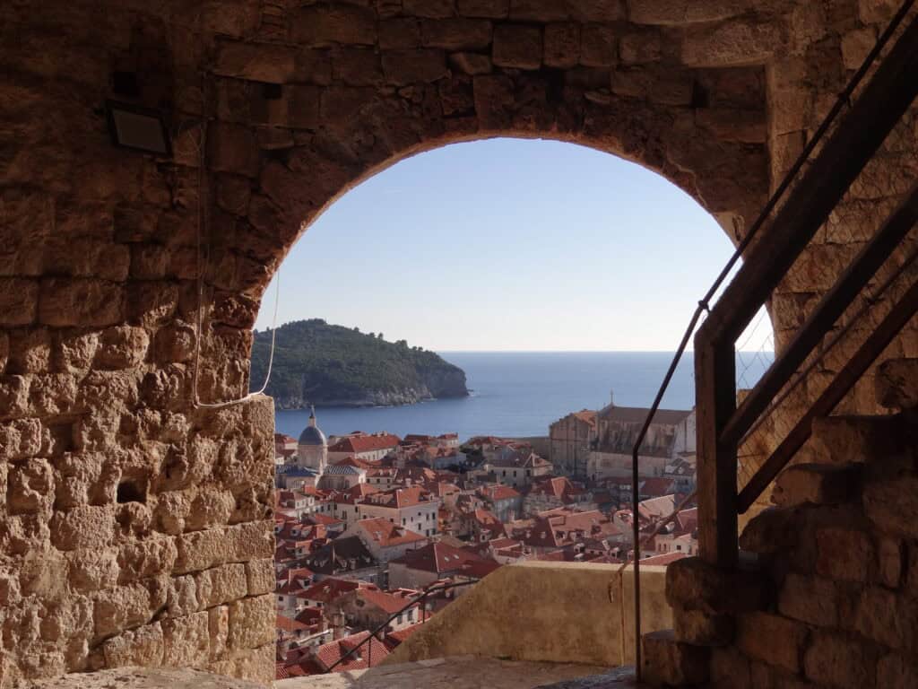 A stunning view from inside Minčeta Tower, showcasing Dubrovnik’s Old Town, red rooftops, and the Adriatic Sea.