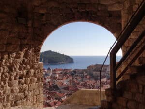 A stunning view from inside Minčeta Tower, showcasing Dubrovnik’s Old Town, red rooftops, and the Adriatic Sea.