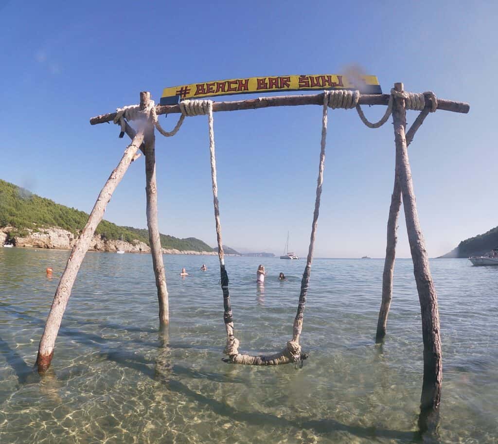 Crystal-clear shallow waters and soft golden sand at Šunj Beach on Lopud Island, the perfect spot for relaxation near Dubrovnik.