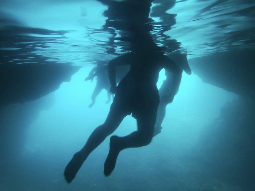 Stunning neon-blue waters inside the Blue Cave on Koločep Island, a breathtaking natural attraction near Dubrovnik, perfect for swimming and snorkeling.