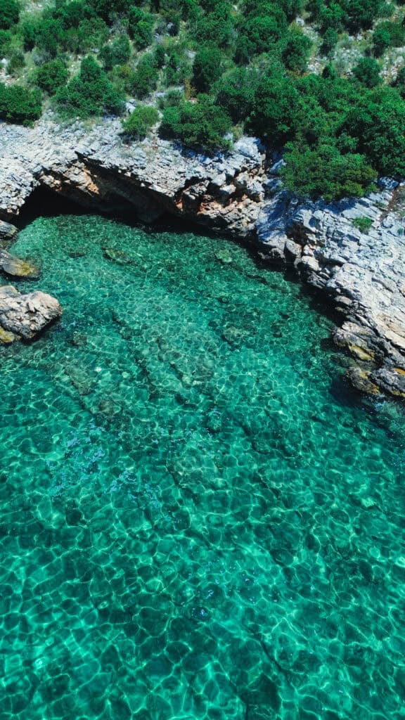 Stunning turquoise waters of Sikirica Blue Lagoon, a secluded Adriatic gem near Dubrovnik, perfect for swimming and snorkeling.